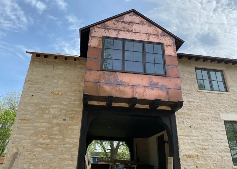Copper metal panel facade on a stone building for Roof Repair in Clarkstown