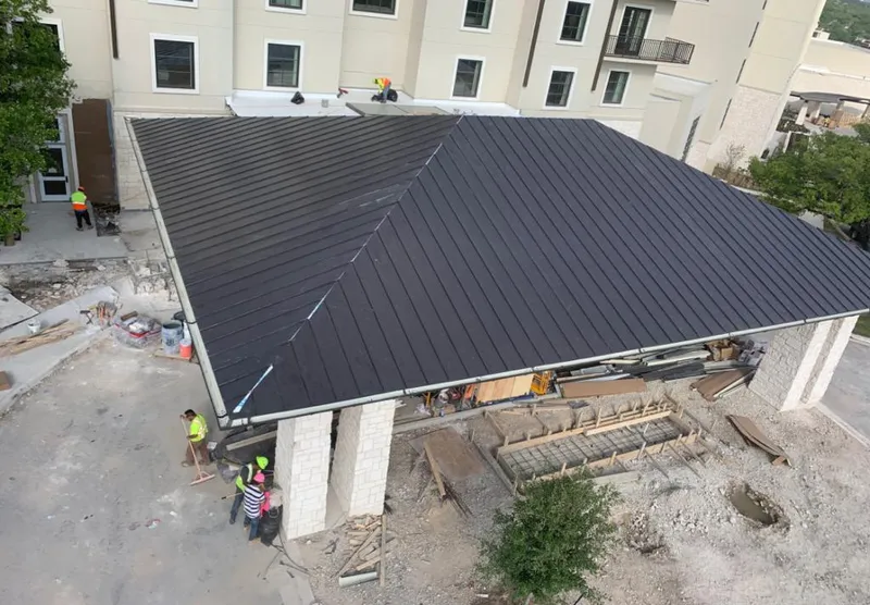Metal roofing installation team working on a commercial building in Clarkstown